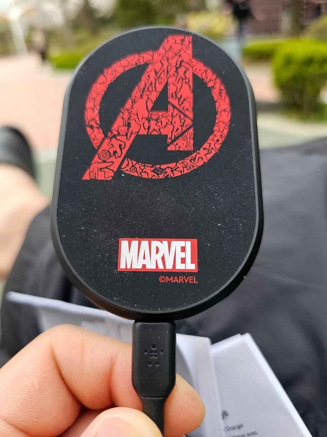 Front face of the charger with the Avengers A logo in red, made up of tiny character silhouettes, and a Marvel logo below