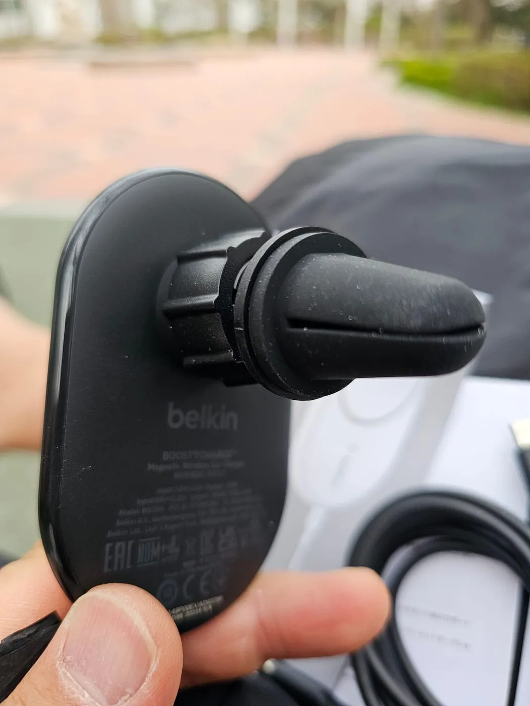 The vent clip attached to the back of the charger via a ball joint